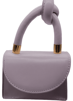 Small lavender handbag with gold accents and a knotted handle