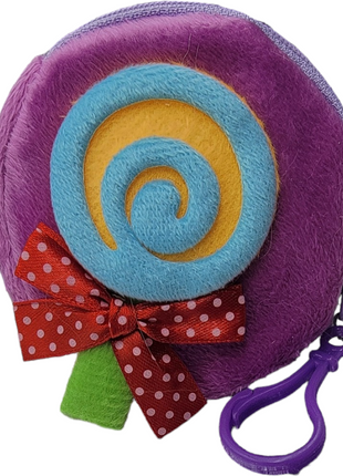 A cute, round pouch designed to look like a lollipop with a purple border, blue and yellow spiral center, a red polka dot bow, and a green stick. It has a purple clip attached.