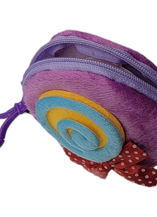 A purple plush keychain pouch with a swirl design and a red polka dot bow.