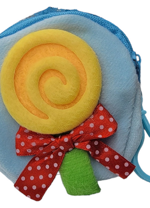 Small blue coin purse with yellow lollipop decoration and red polka dot bow