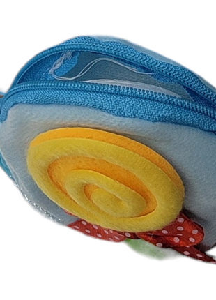 Small blue plush zippered coin purse with a yellow spiral design and a red polka dot bow.