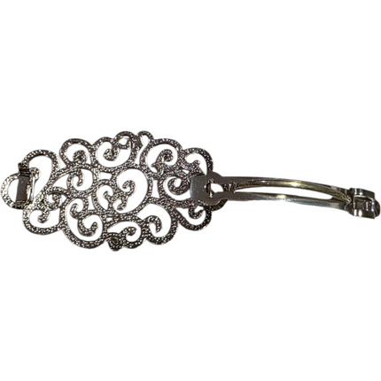 Intricate silver hair brooch measuring 8cm by 4cm with decorative filigree design
