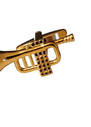 Golden trumpet pin on a white background