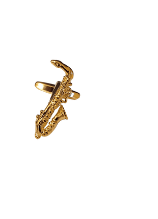 Gold saxophone-shaped cufflink against a white background