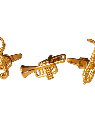 Gold cufflinks in the shape of a treble clef, trumpet, and saxophone.