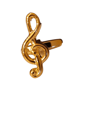 Gold treble clef-shaped ring on a white background