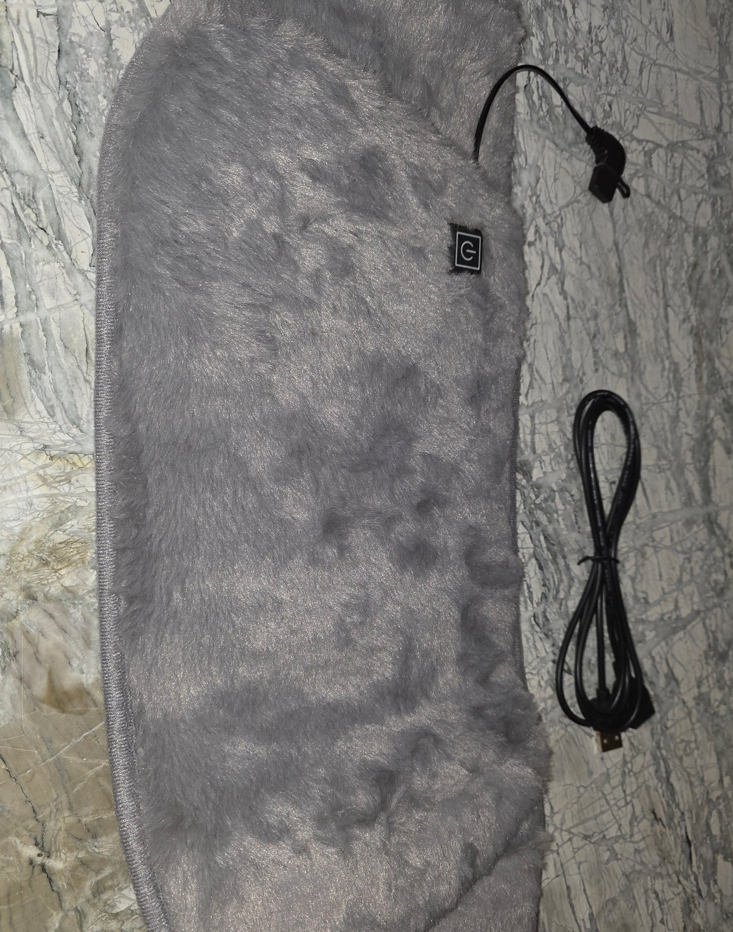 Soft grey heated blanket with furry texture and USB connection for warmth and comfort.