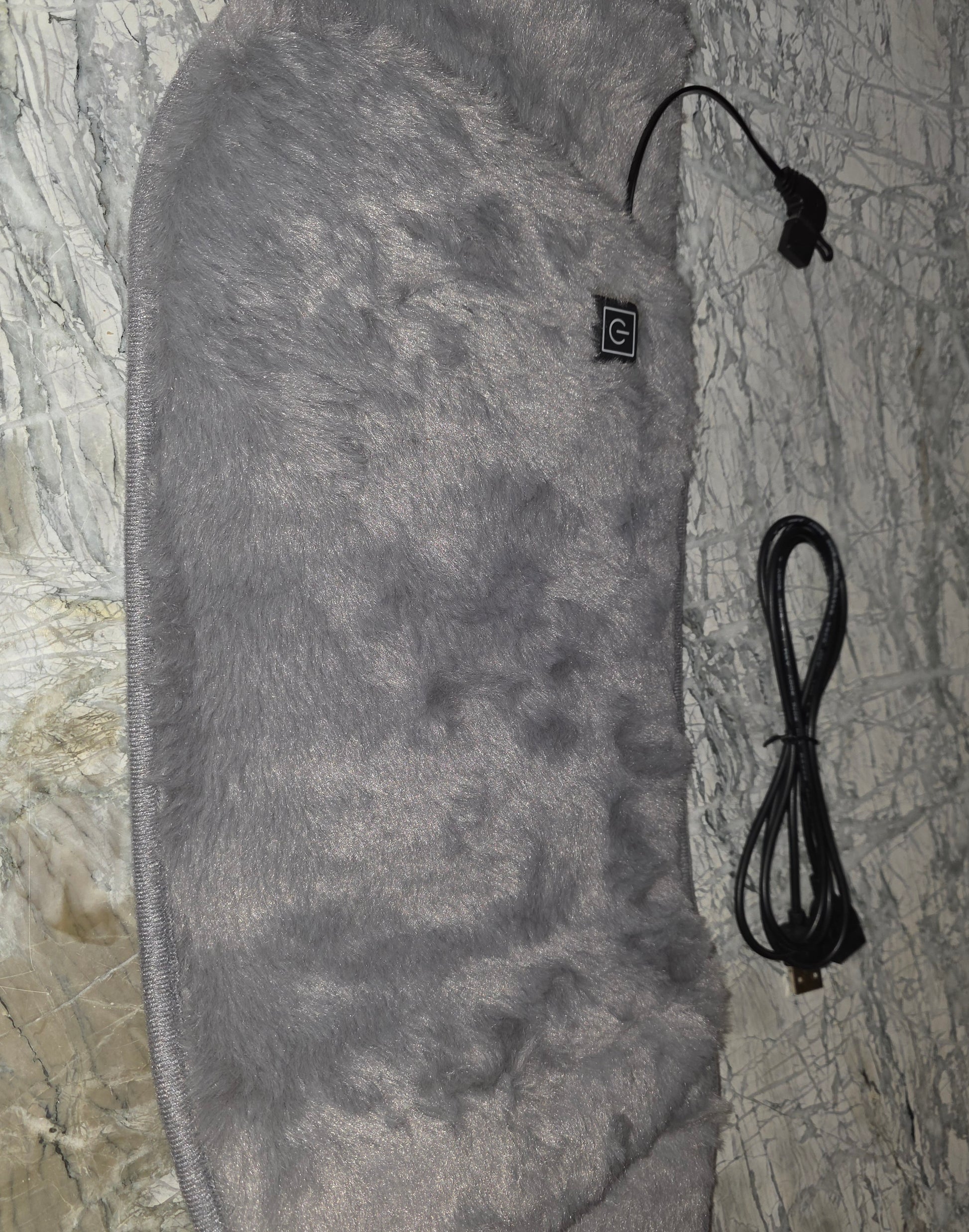 Soft grey heated blanket with furry texture and USB connection for warmth and comfort.