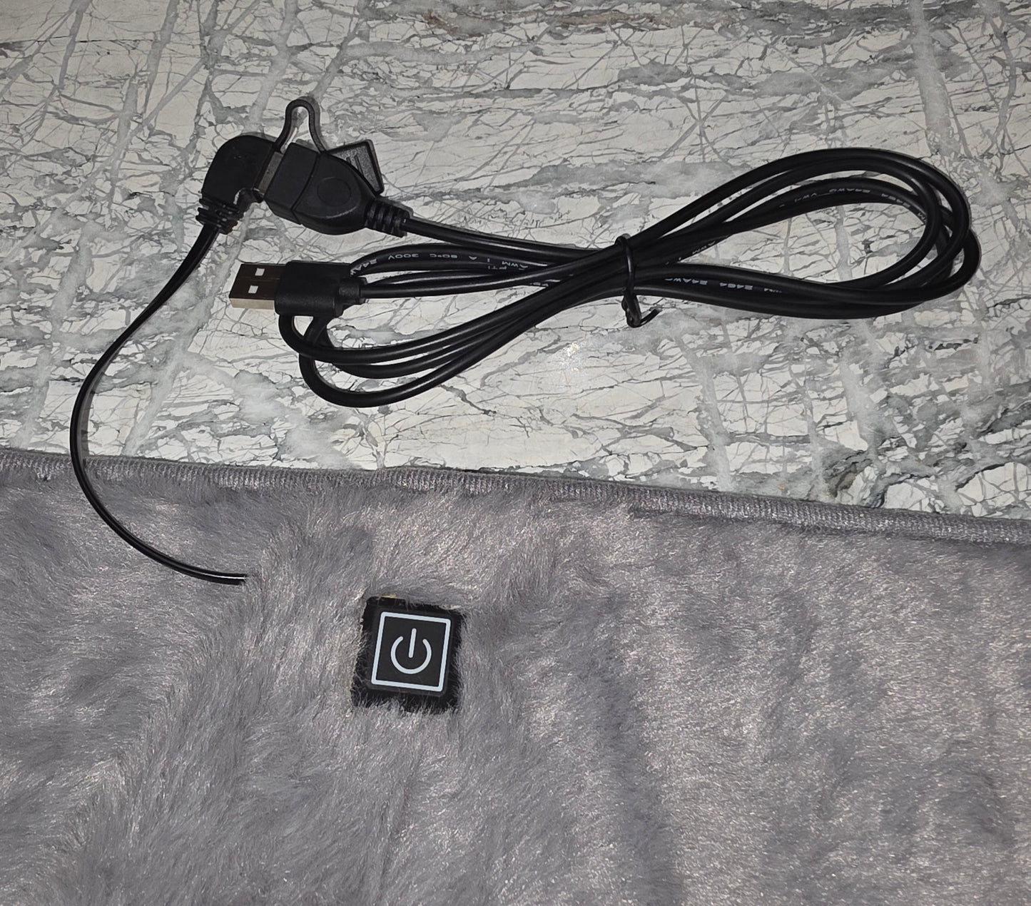 Gray electric blanket with USB and power cord, featuring an easy-to-use power button.