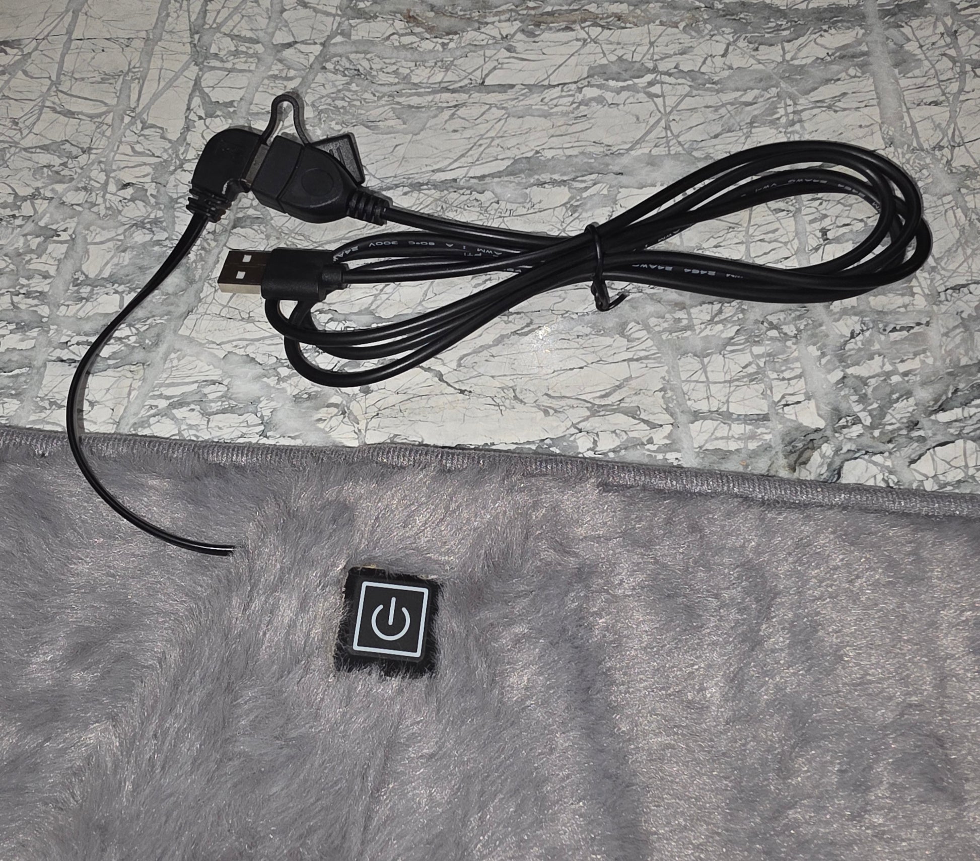 Gray electric blanket with USB and power cord, featuring an easy-to-use power button.